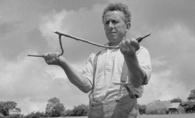 In 1942, George Casely uses a hazel twig to use in dowsing for water on the land around his Devon farm.